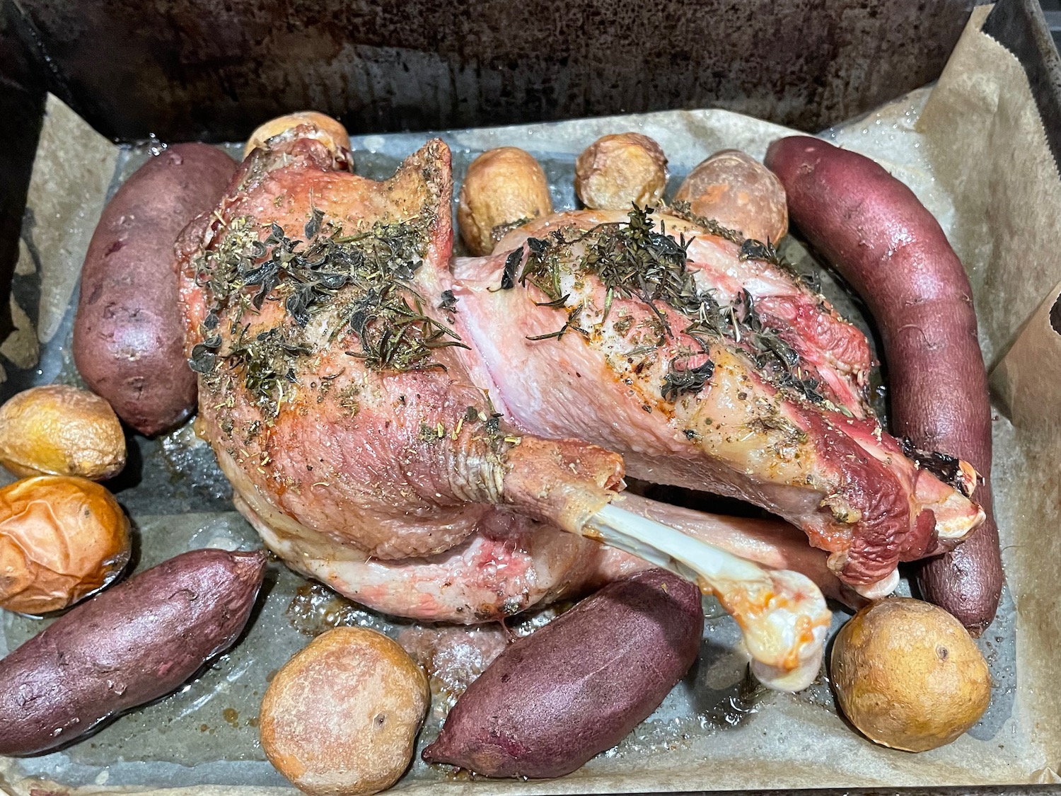 a chicken and potatoes on a tray