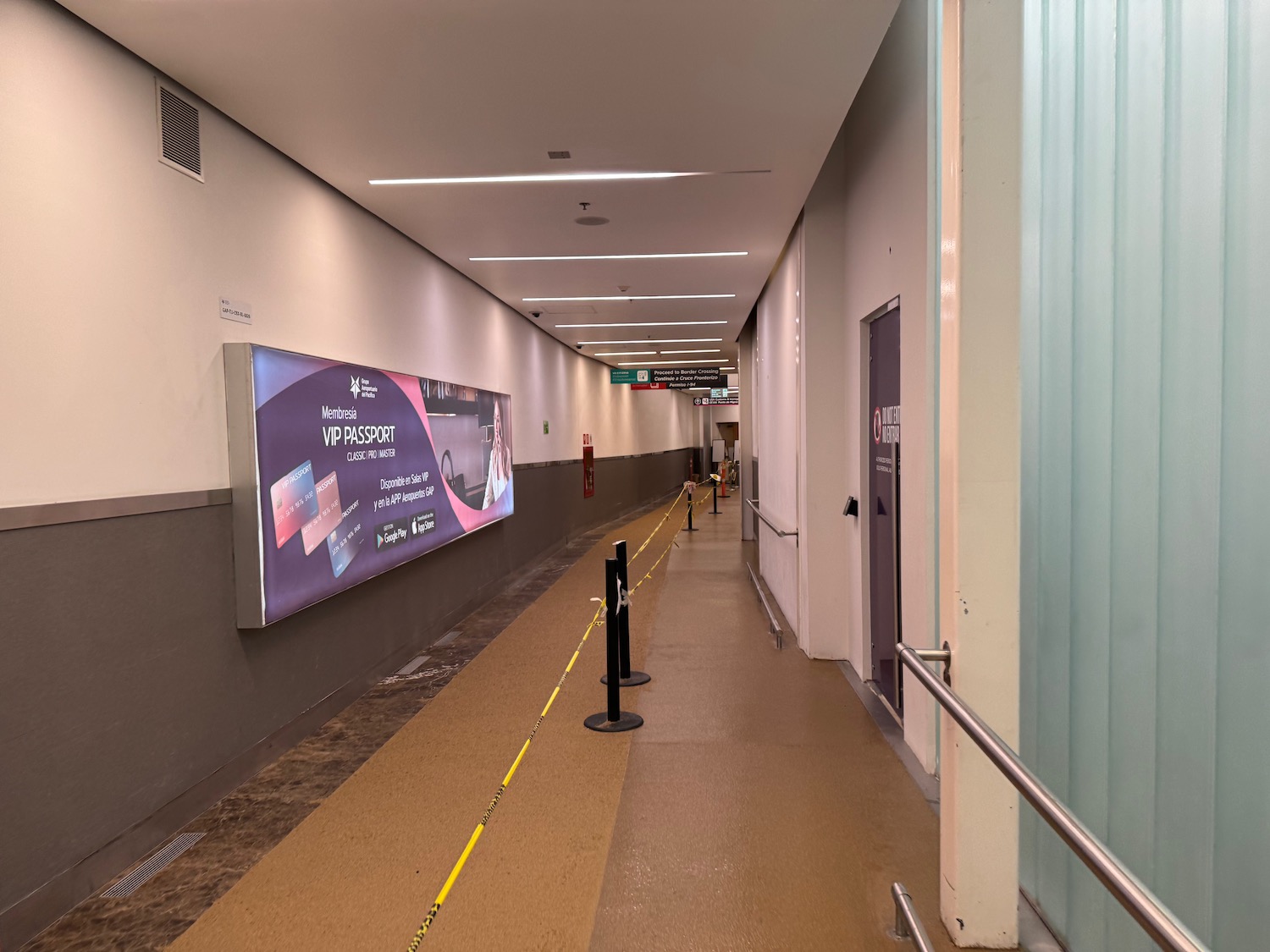 a long hallway with a sign on the wall