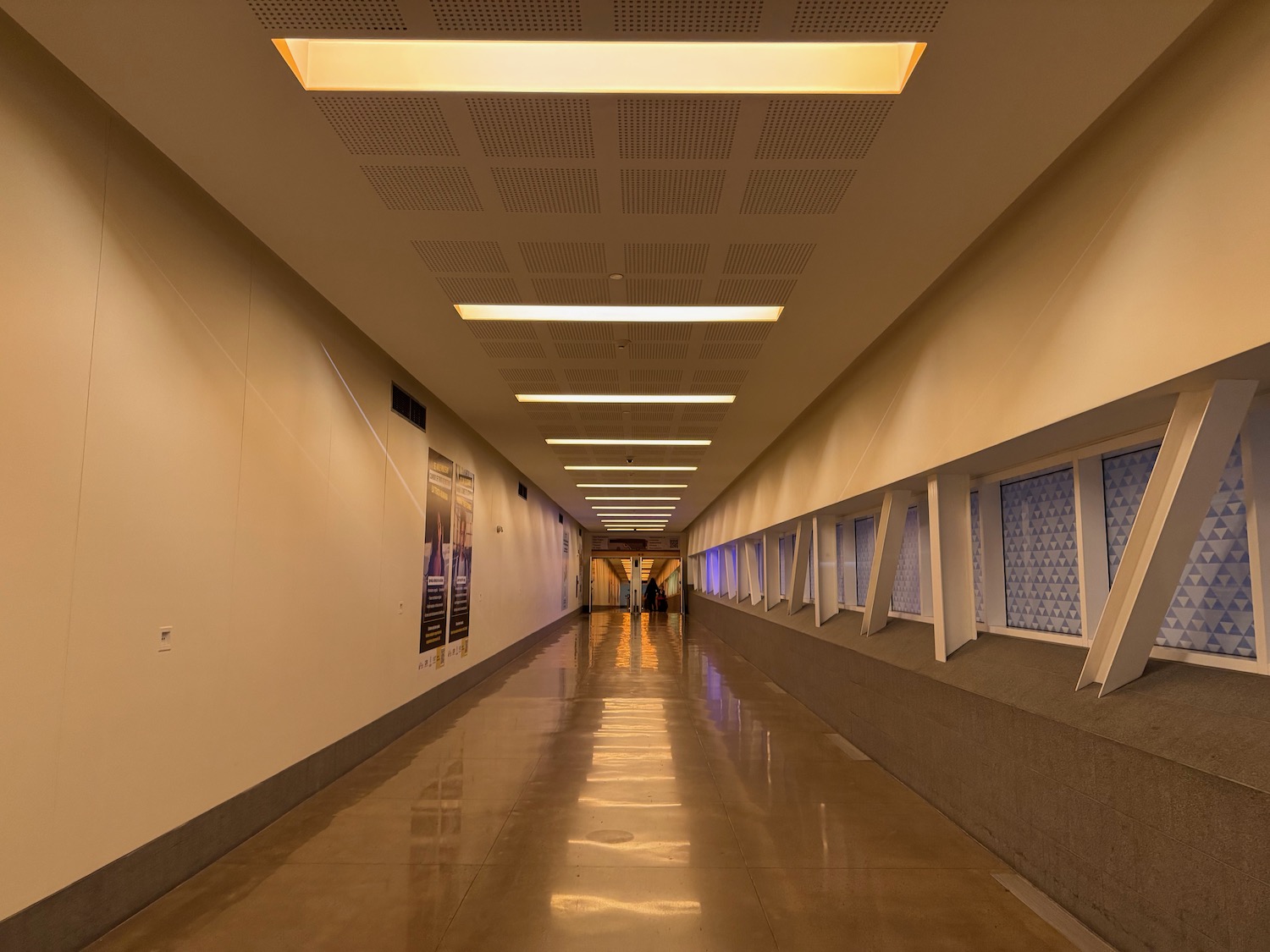 a long hallway with a couple of people walking