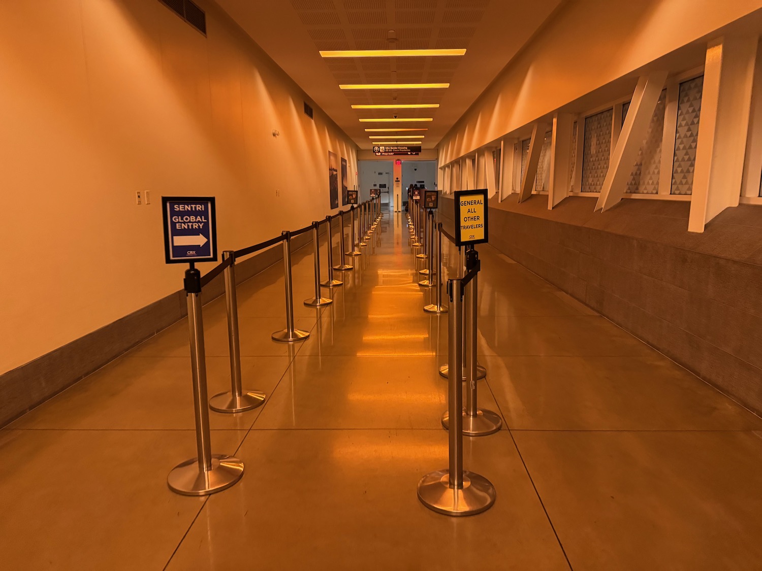 a long hallway with a row of barriers