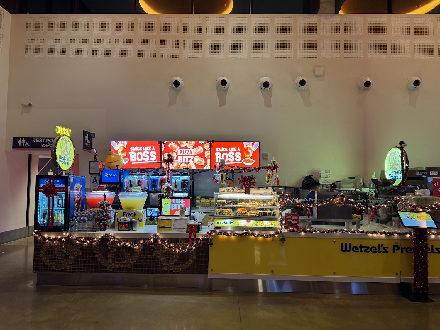 a food stand with lights and a sign