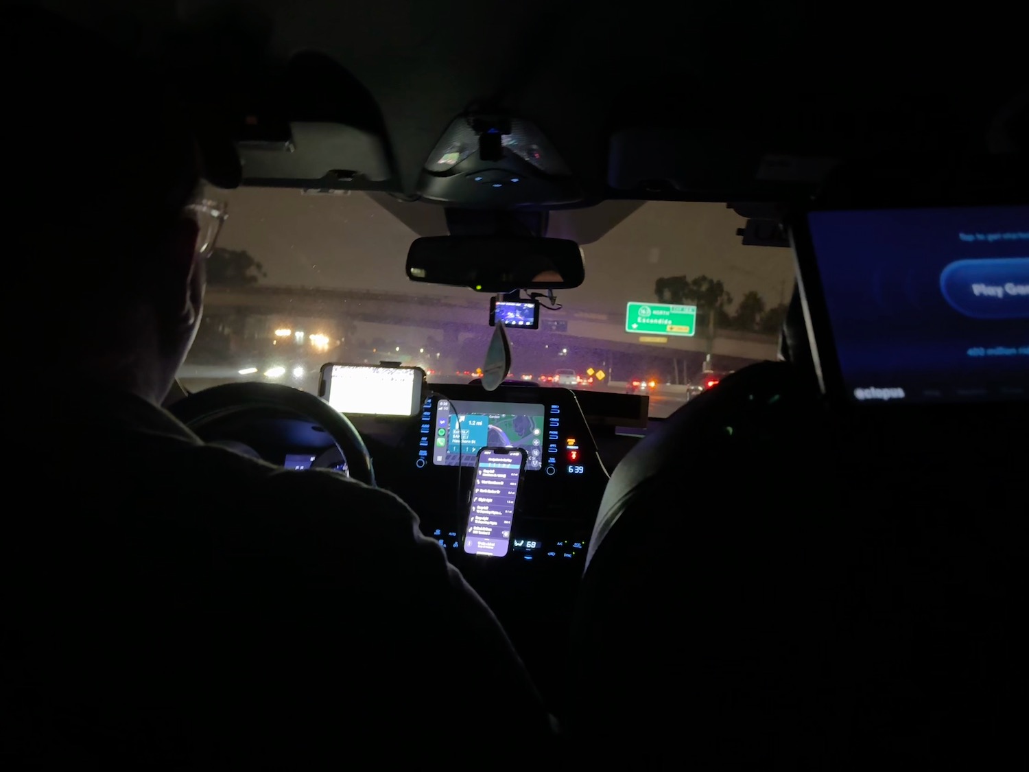 a man driving a car at night