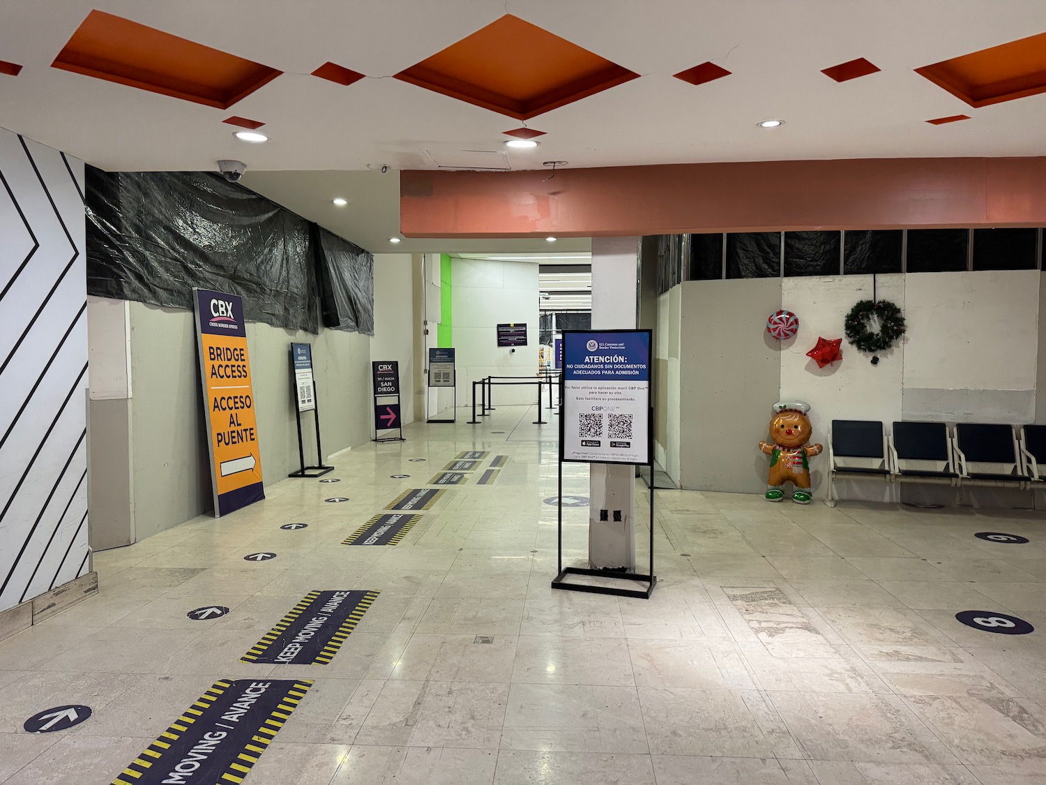 a hallway with signs and chairs