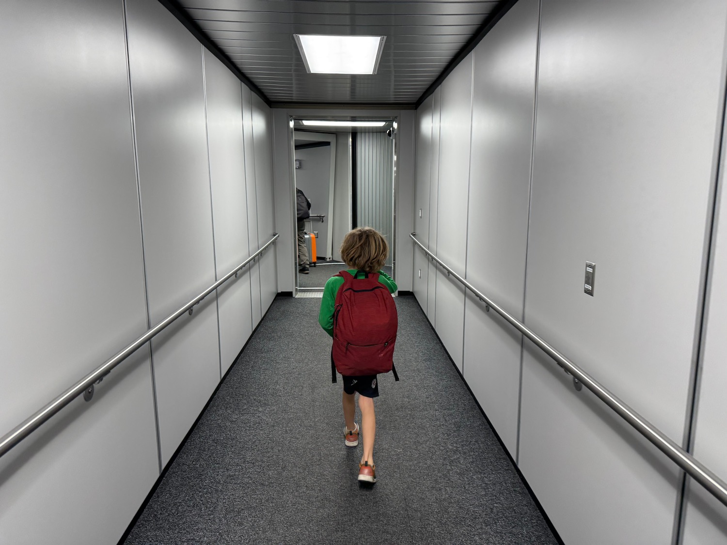 a child walking down a hallway