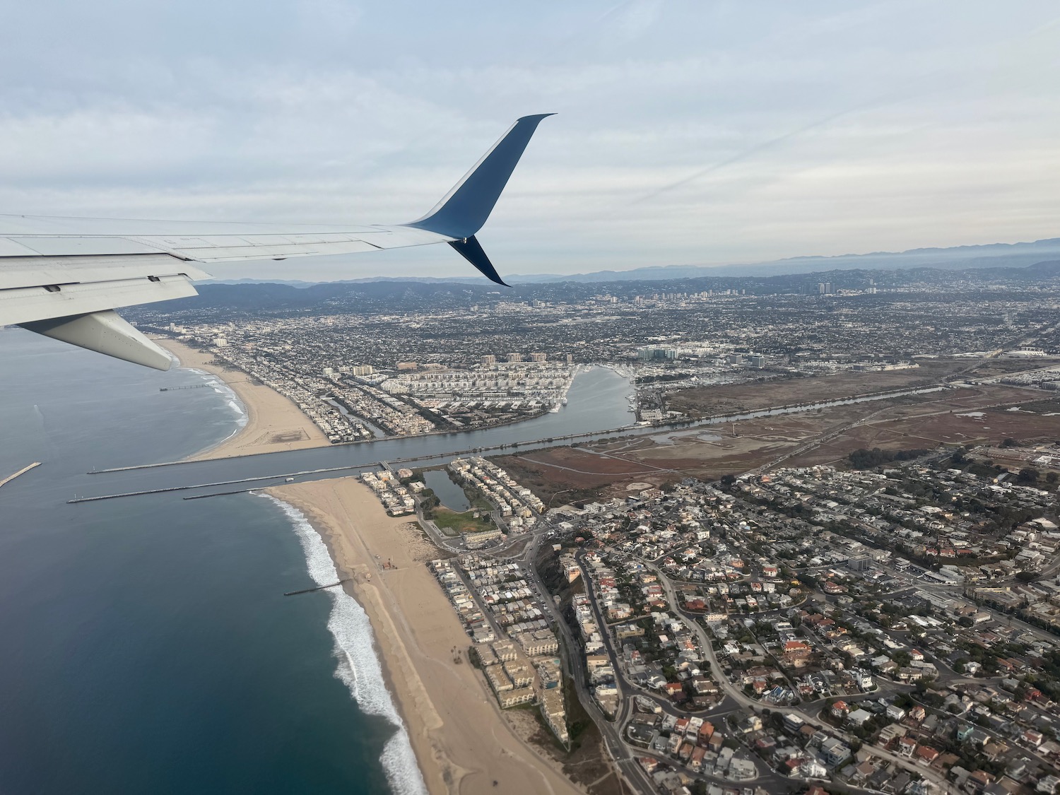 an airplane wing and water and beach