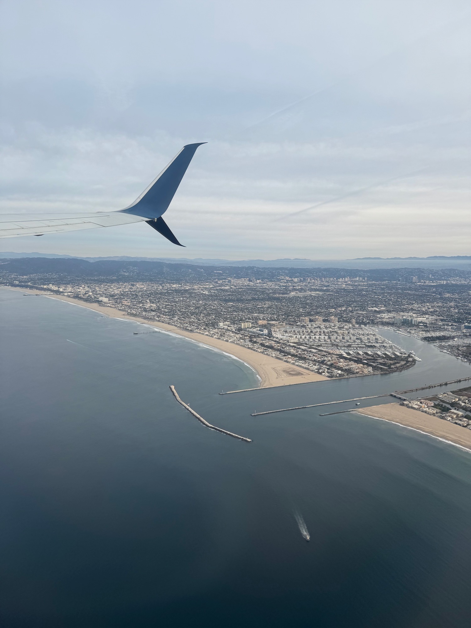 an airplane wing above a body of water