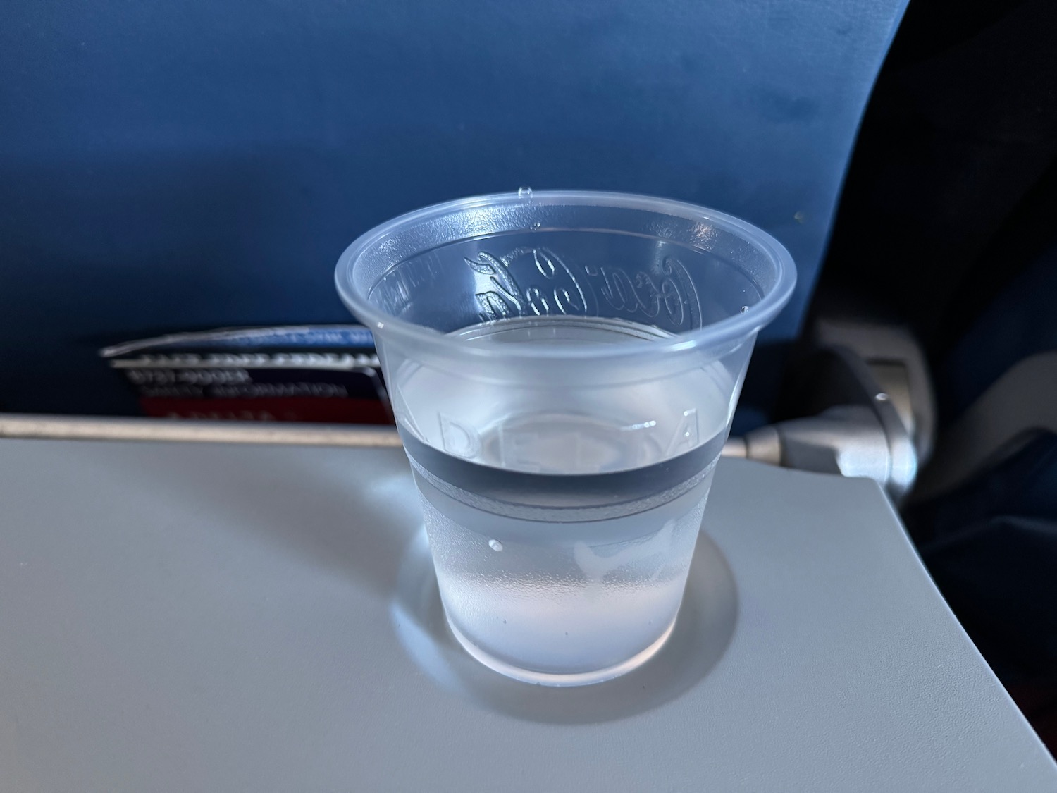 a plastic cup of liquid on a table