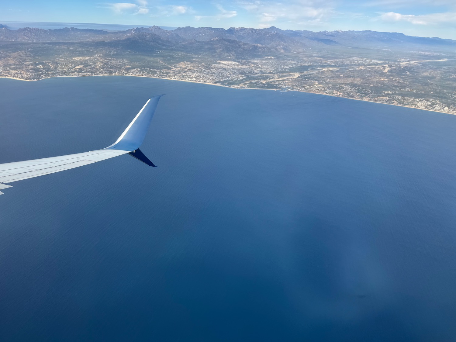 an airplane wing above the water