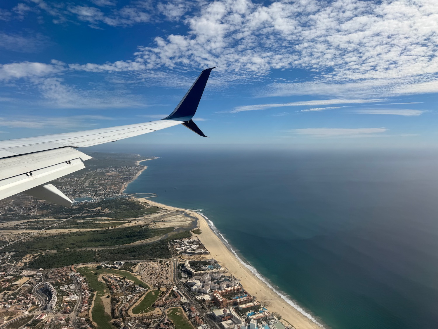 an airplane wing over a beach