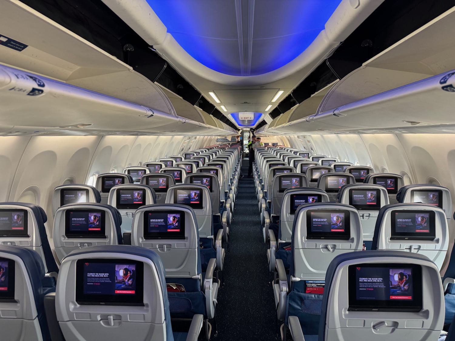 an airplane with rows of seats and monitors