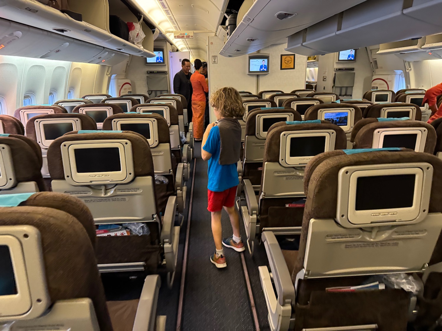 a boy standing in an airplane