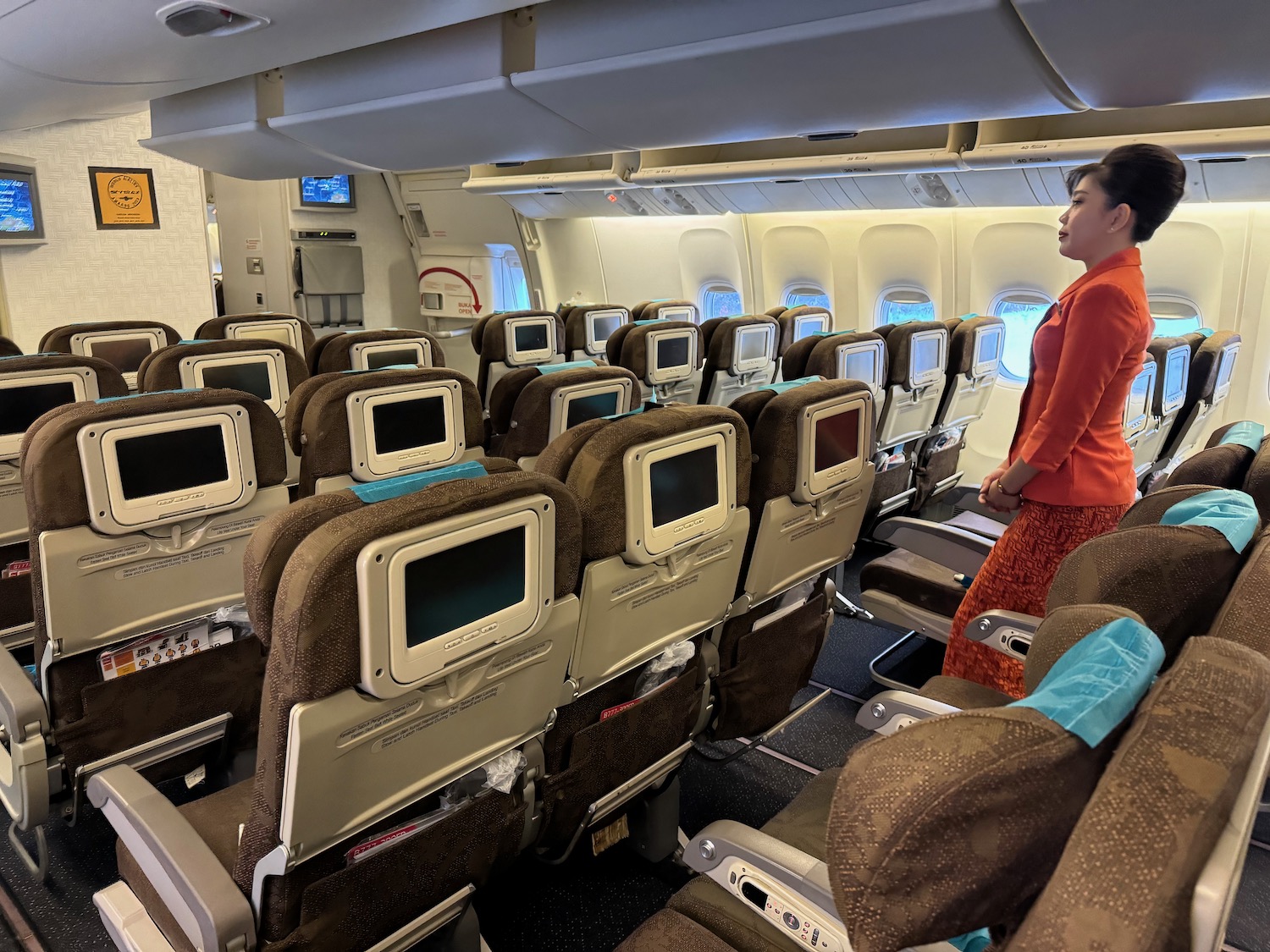 a woman standing in an airplane