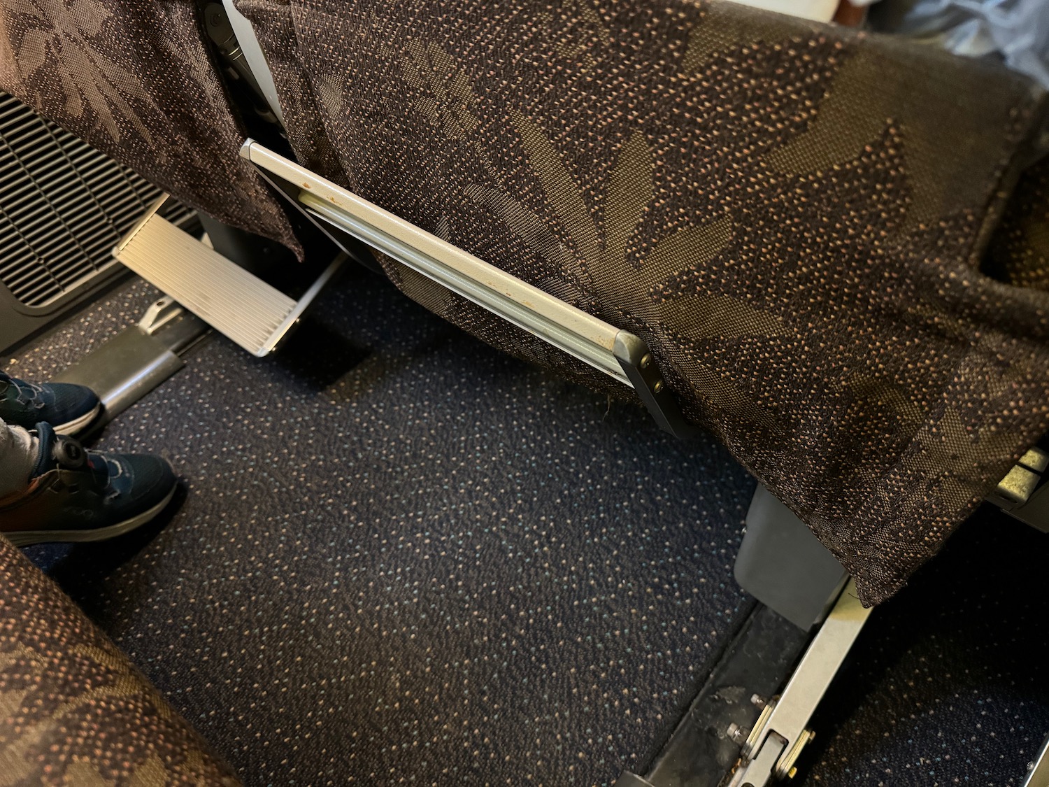 a seat with a brown fabric covering