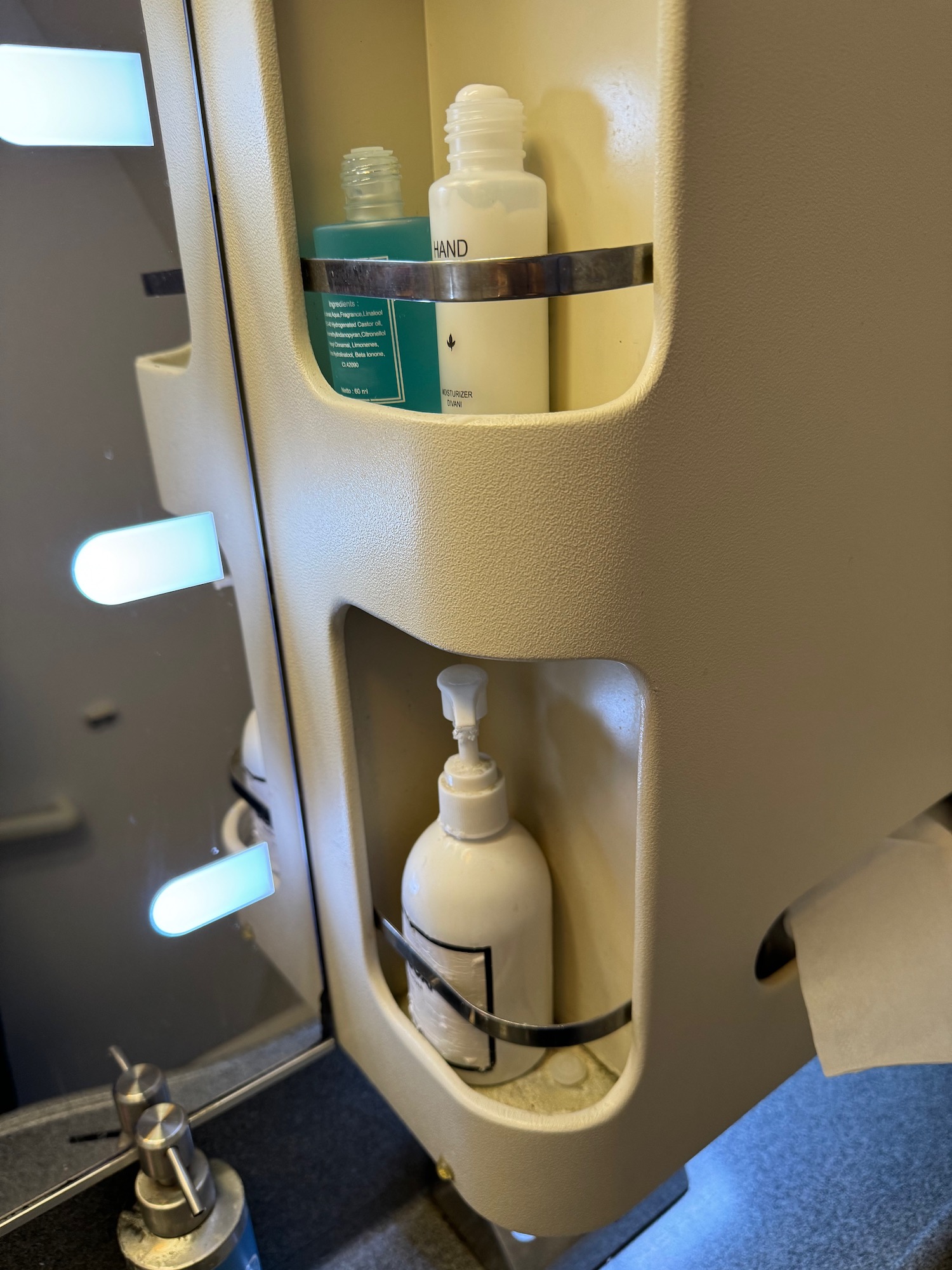 a shelf with bottles of shampoo and soap on it