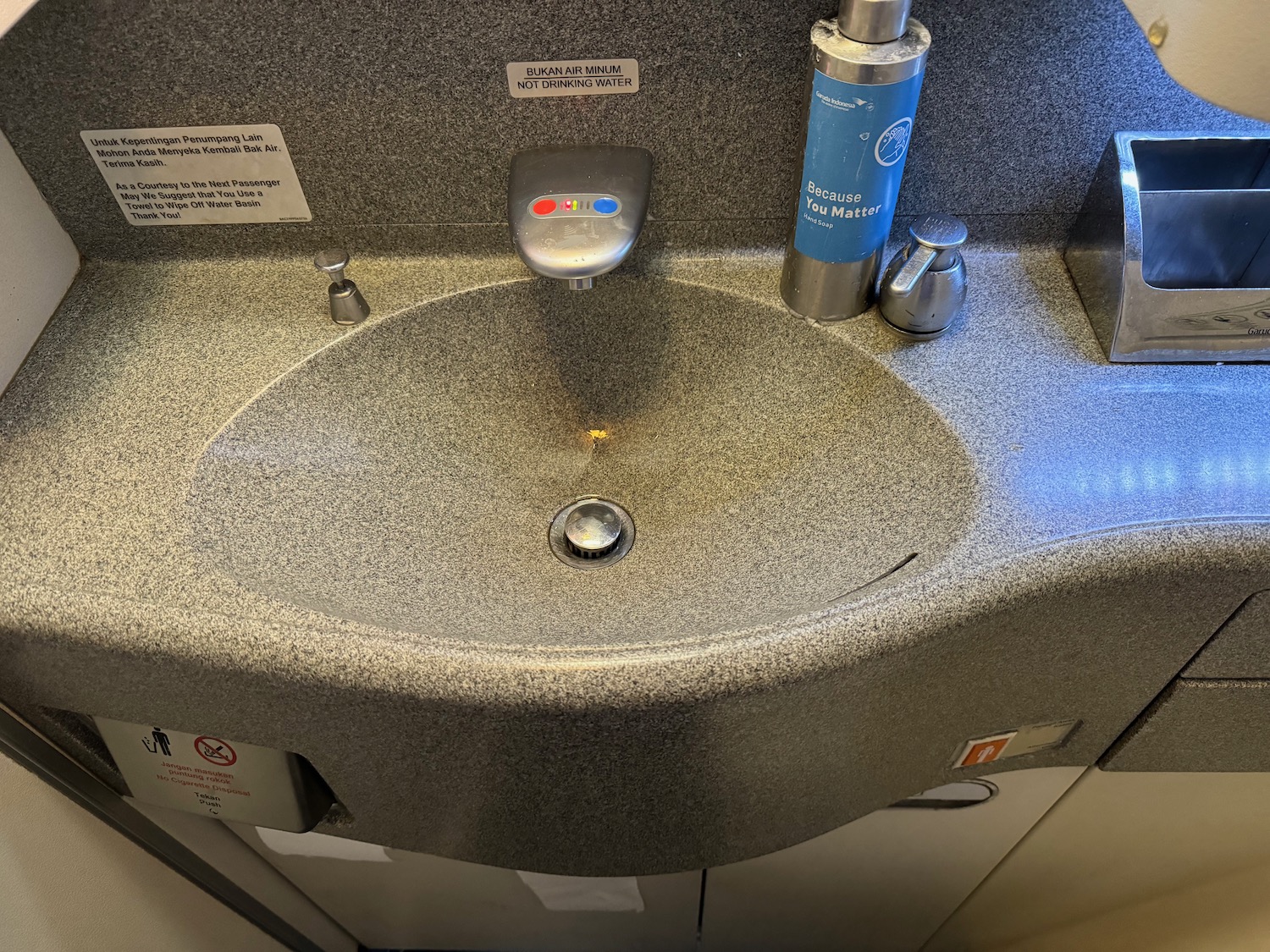 a sink with a soap dispenser