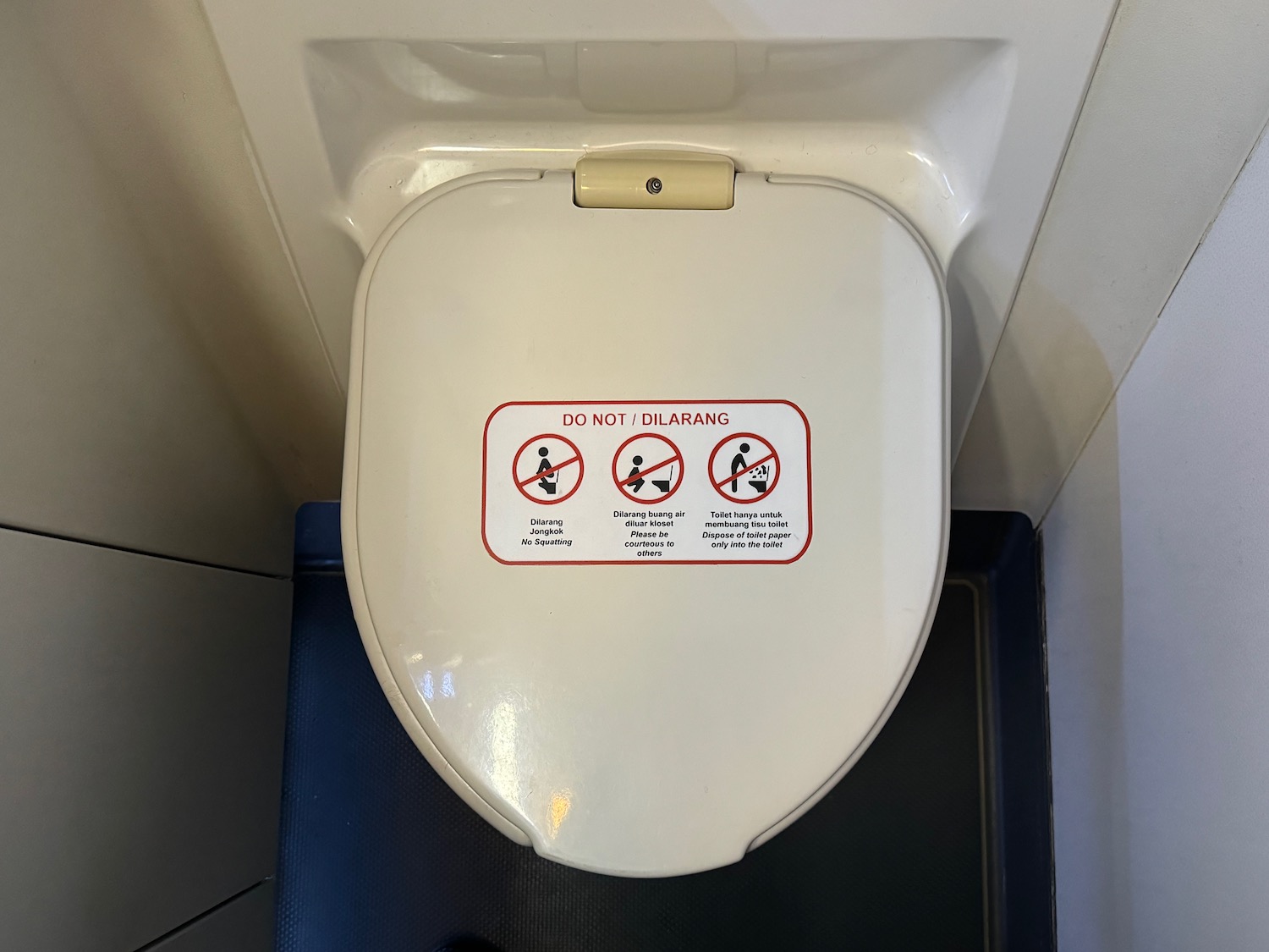 a toilet lid with stickers on it