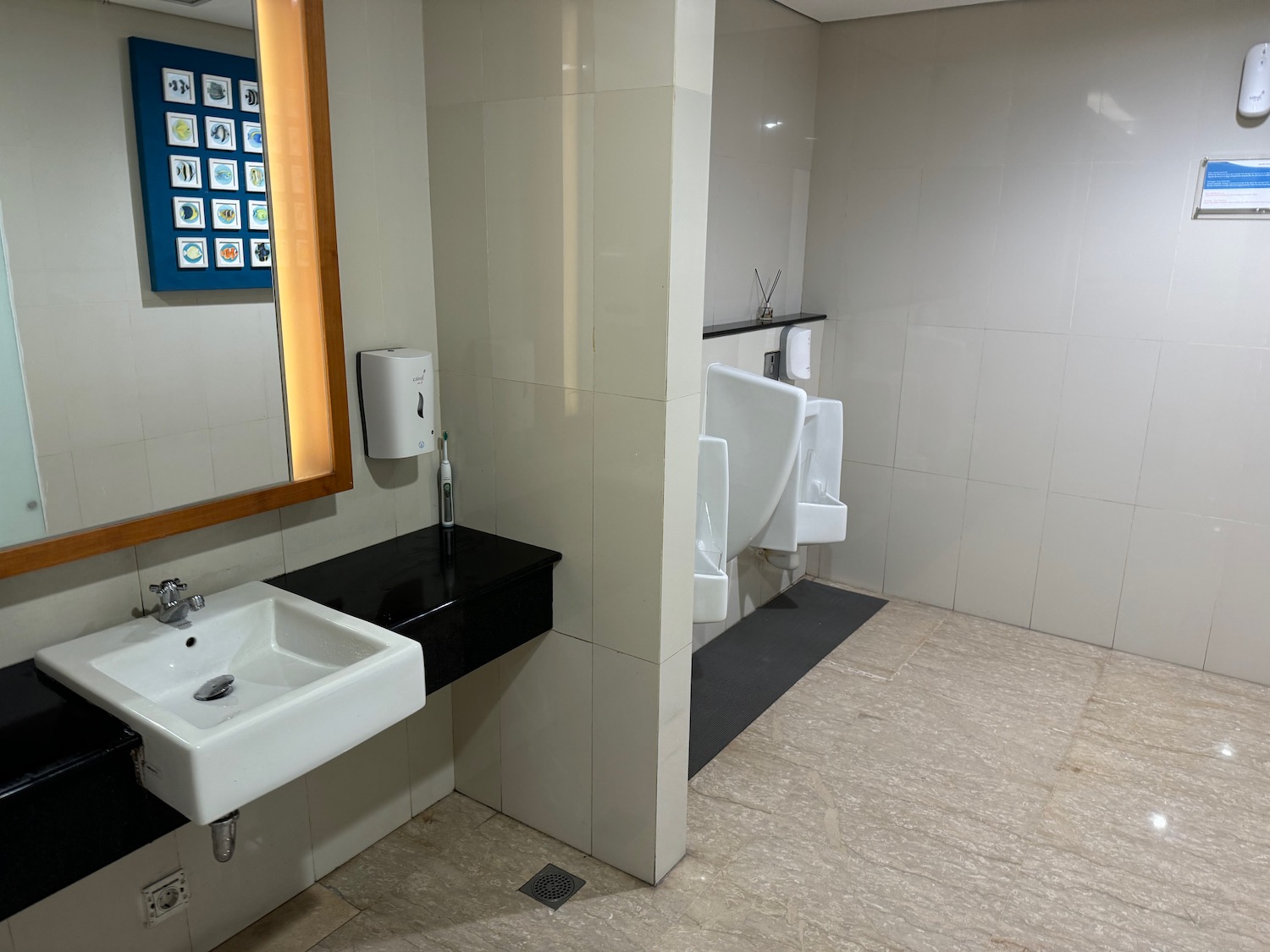 a bathroom with urinals and sink