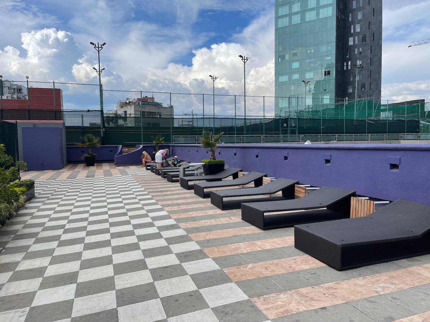 a group of lounge chairs on a rooftop