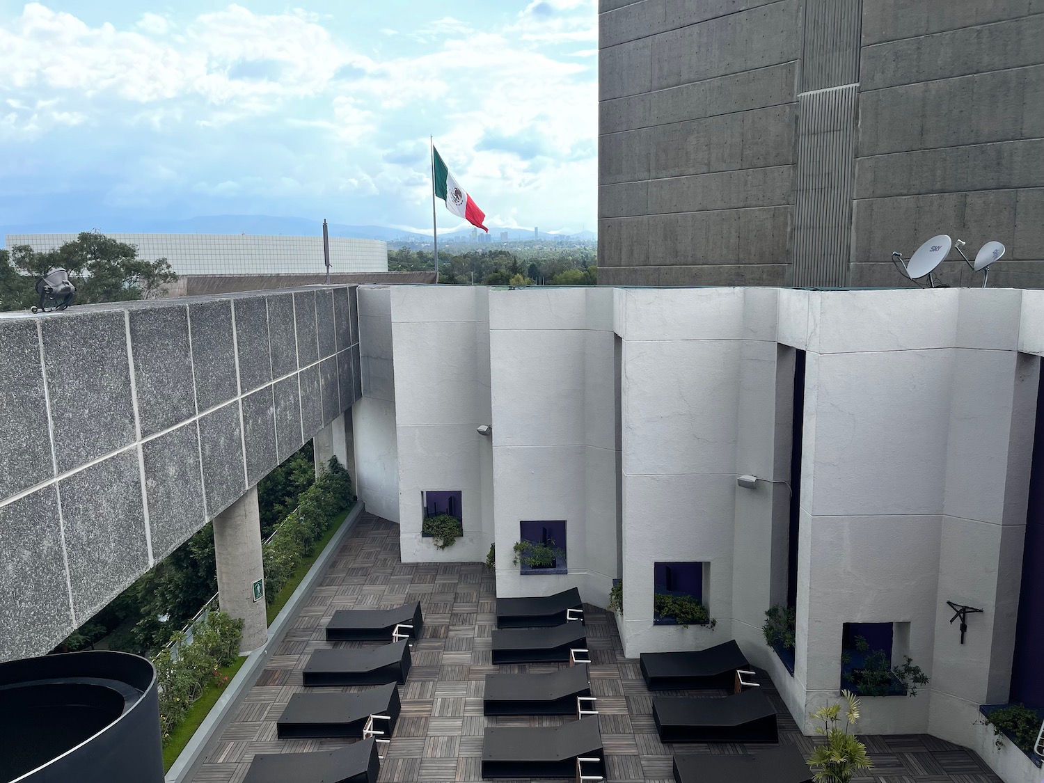 a building with lounge chairs and flags