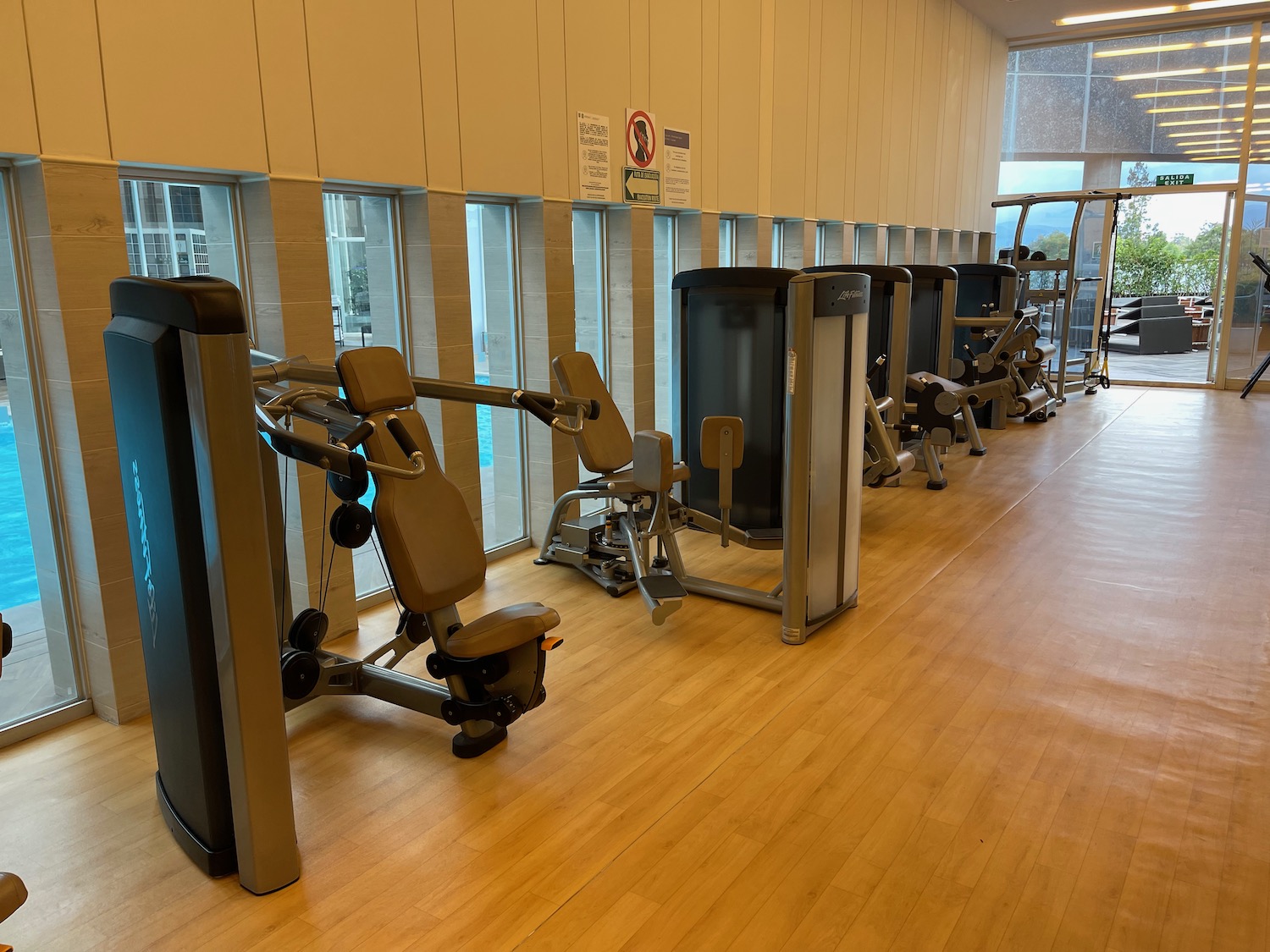 a row of exercise equipment in a gym