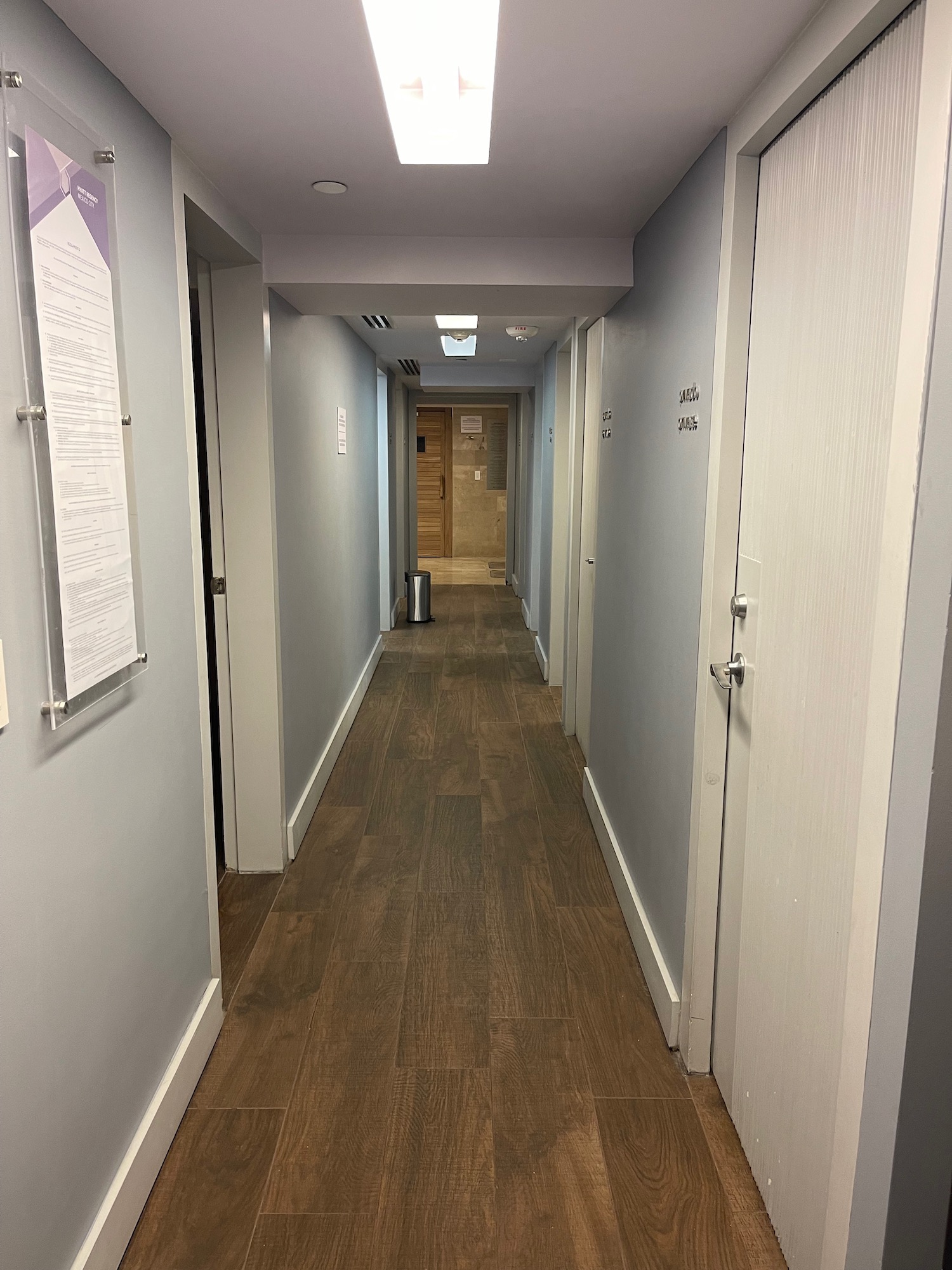 a hallway with doors and a wood floor