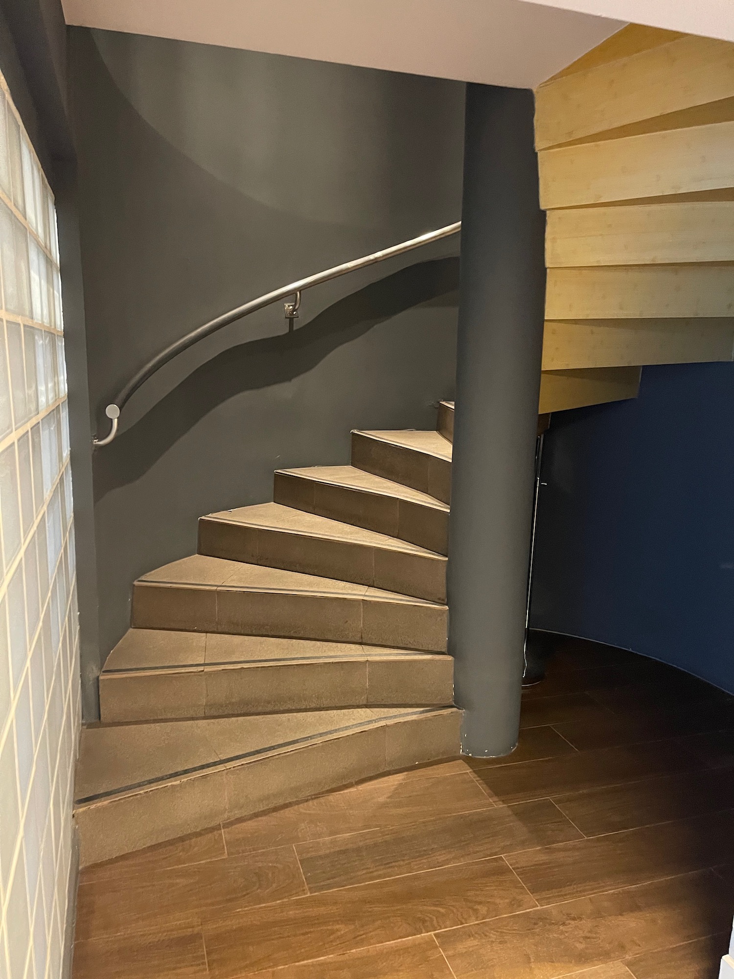 a spiral staircase with a metal handrail