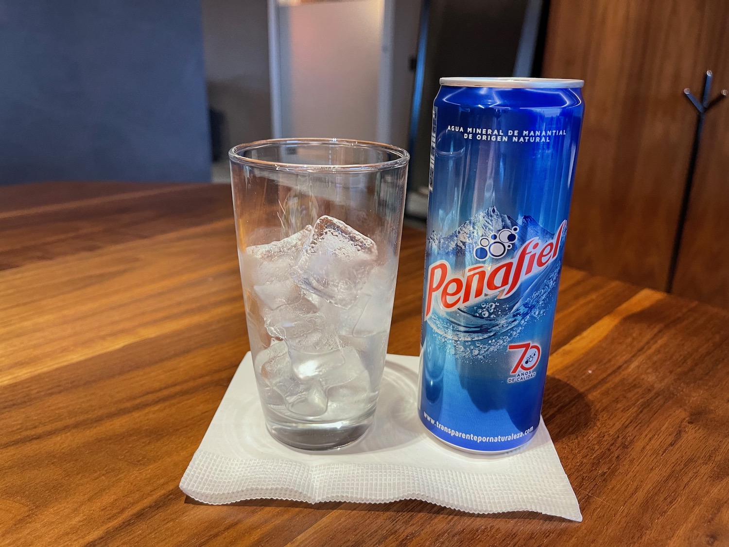 a can and glass of ice on a table