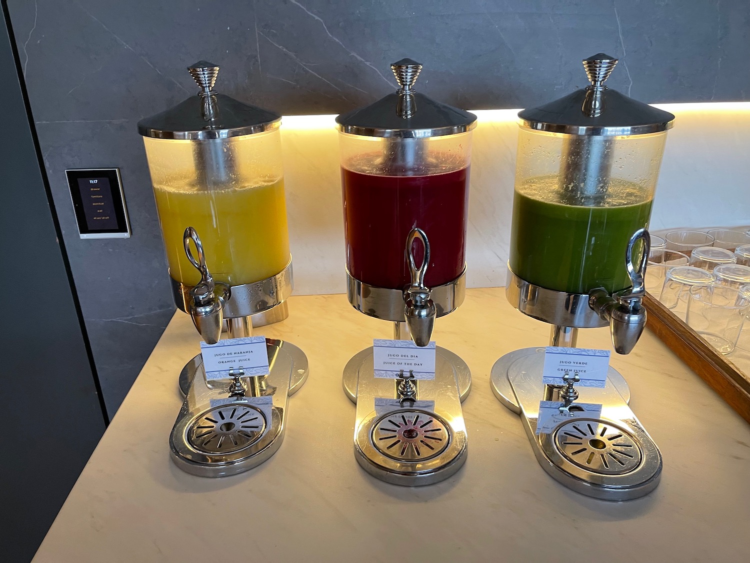 a group of juice dispensers on a table