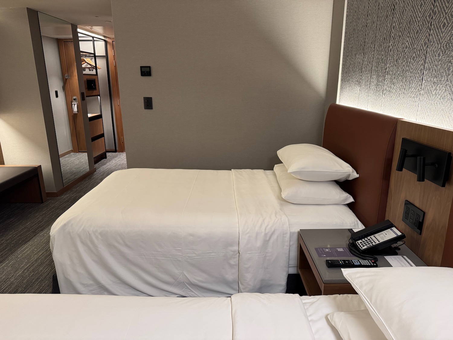 a hotel room with a phone and bed