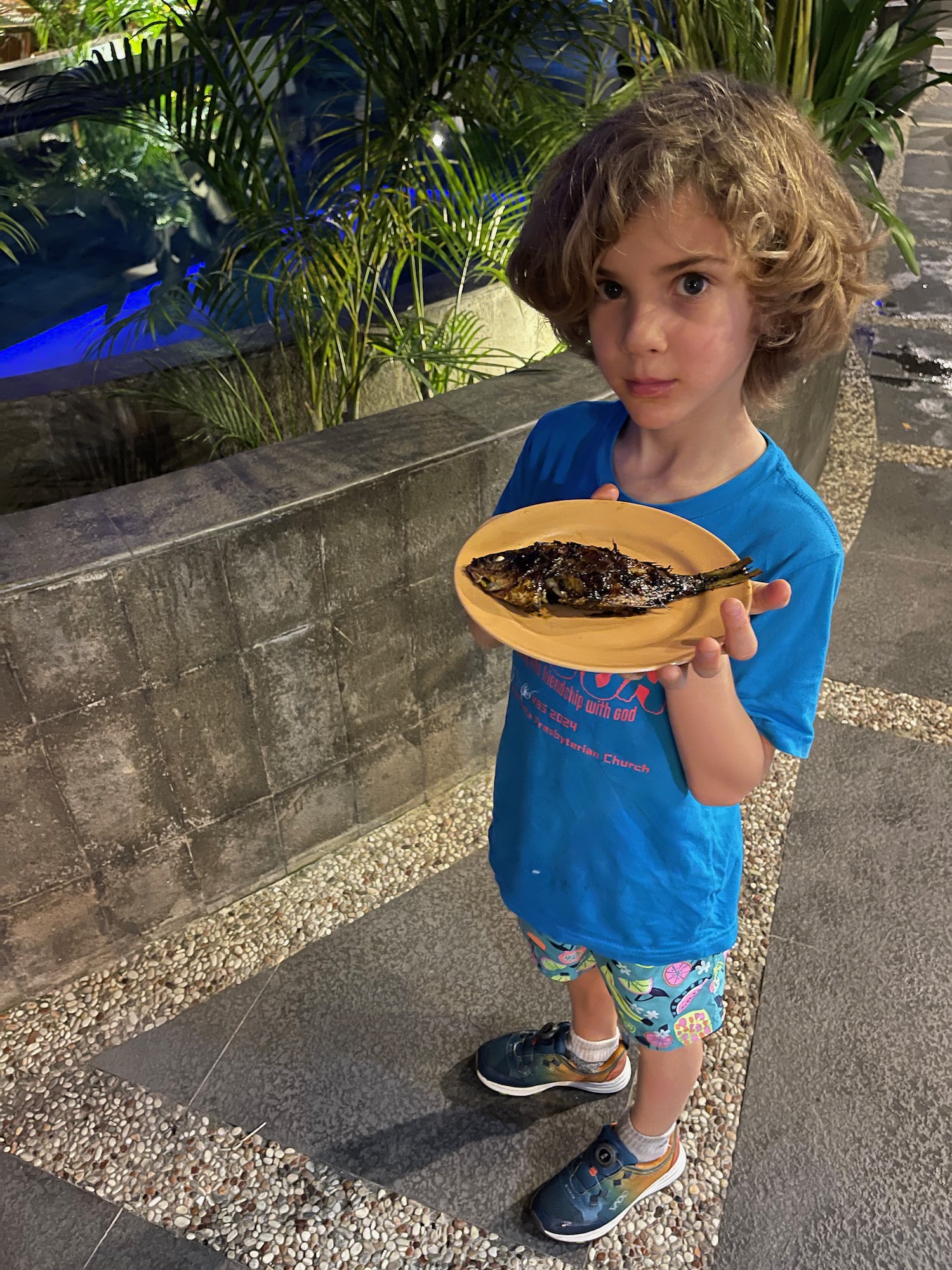 a child holding a plate of food