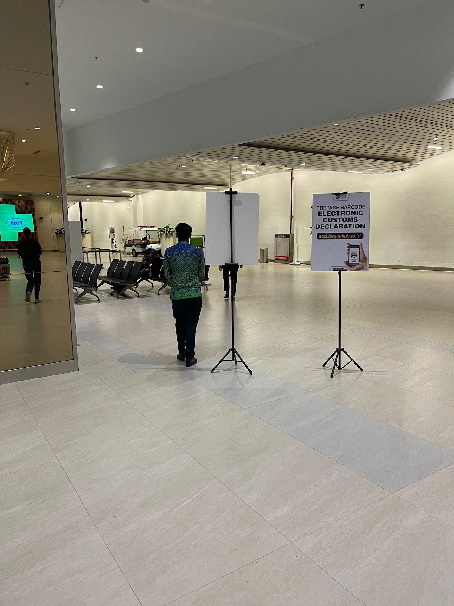 a man standing in a room with a sign