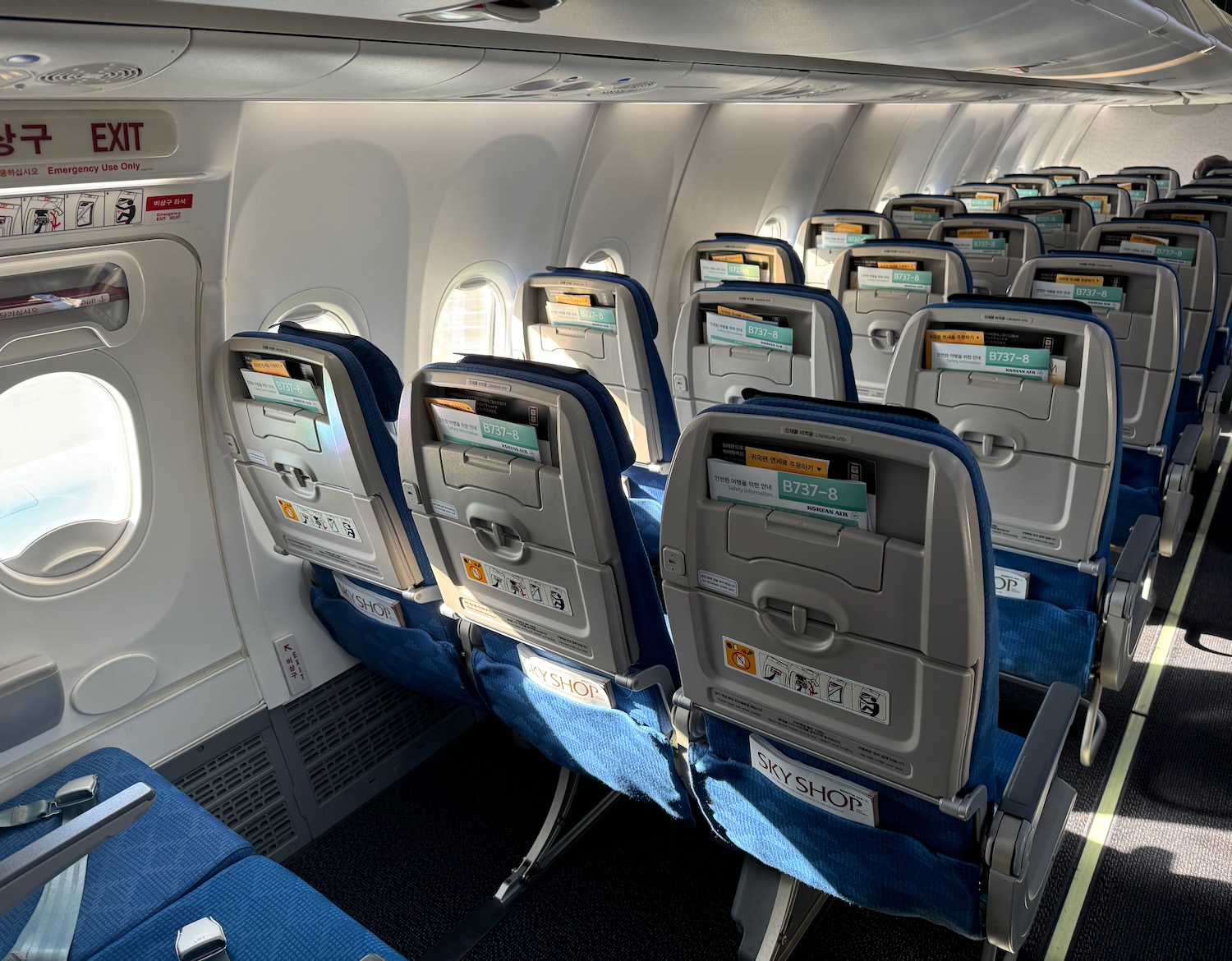 a row of blue seats on an airplane