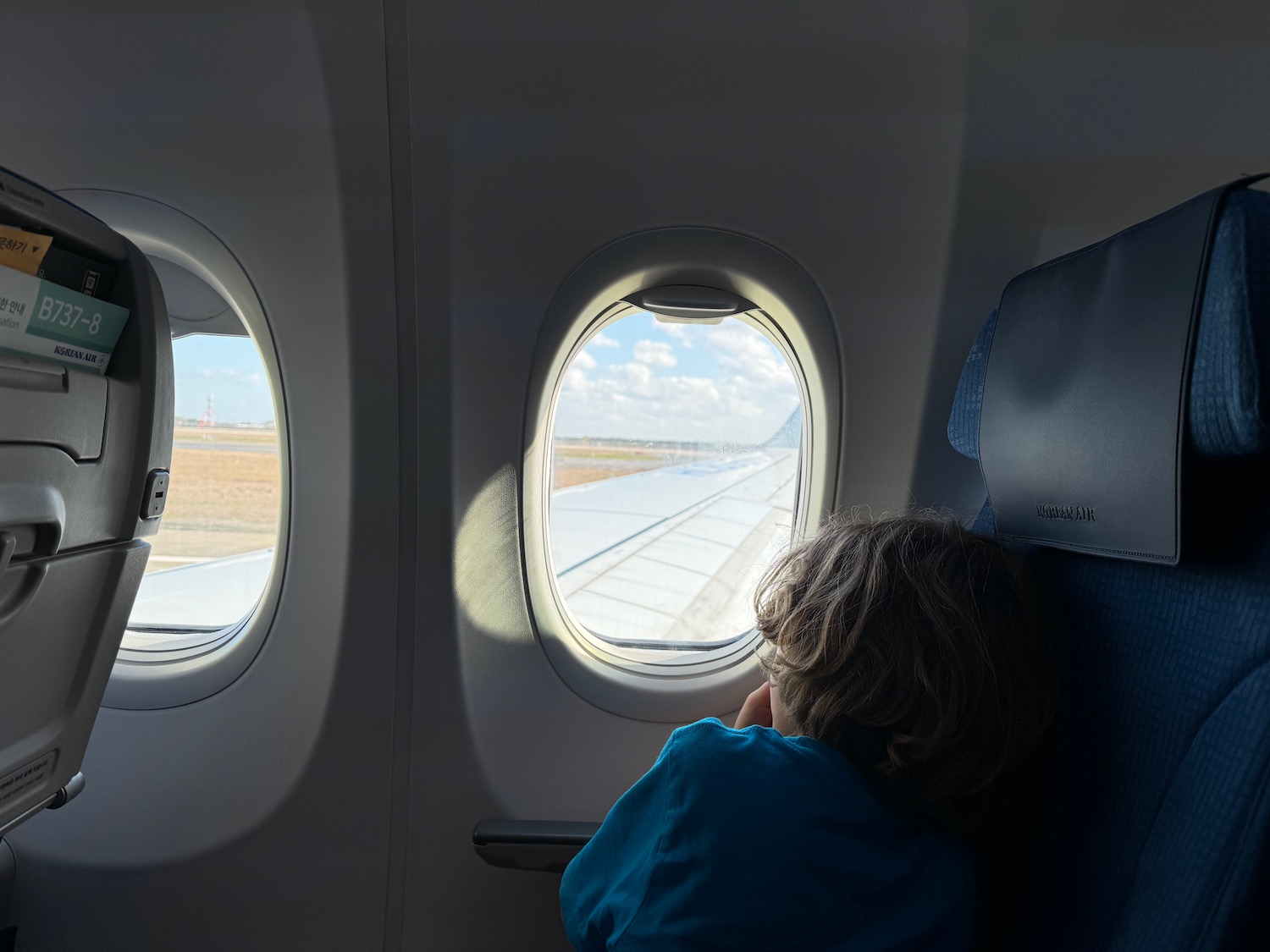 a child looking out of an airplane window