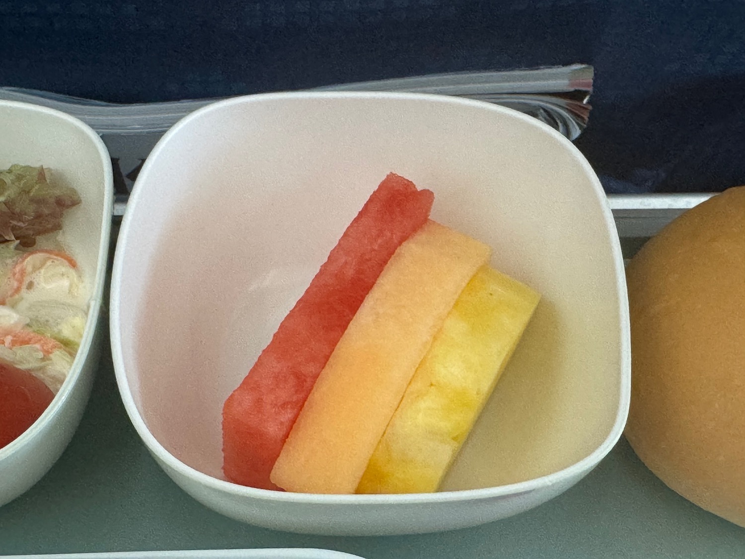 a bowl of fruit in a tray