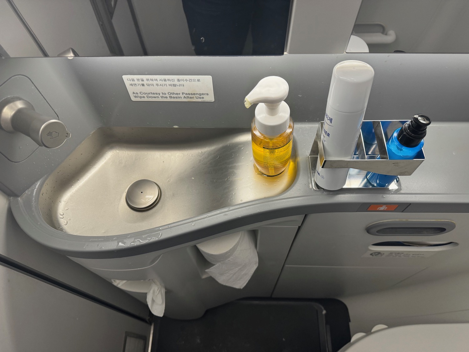 a sink with soap and shampoo on it