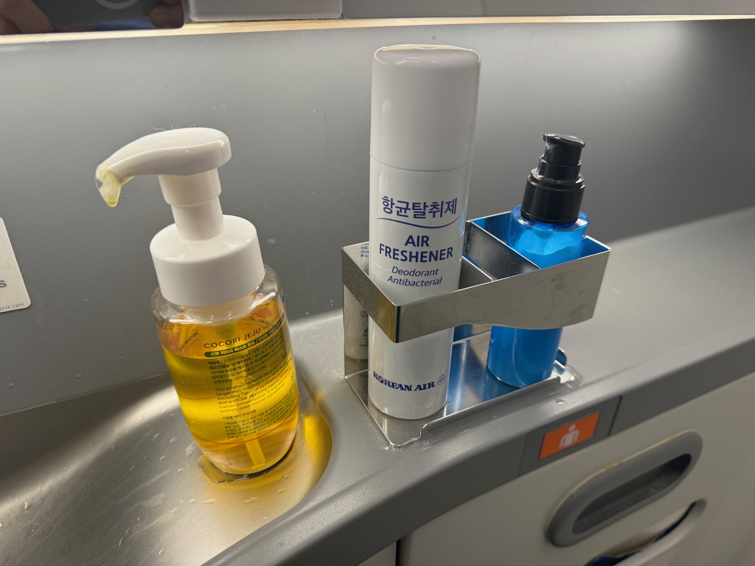 a group of bottles of hand sanitizer and soap on a shelf