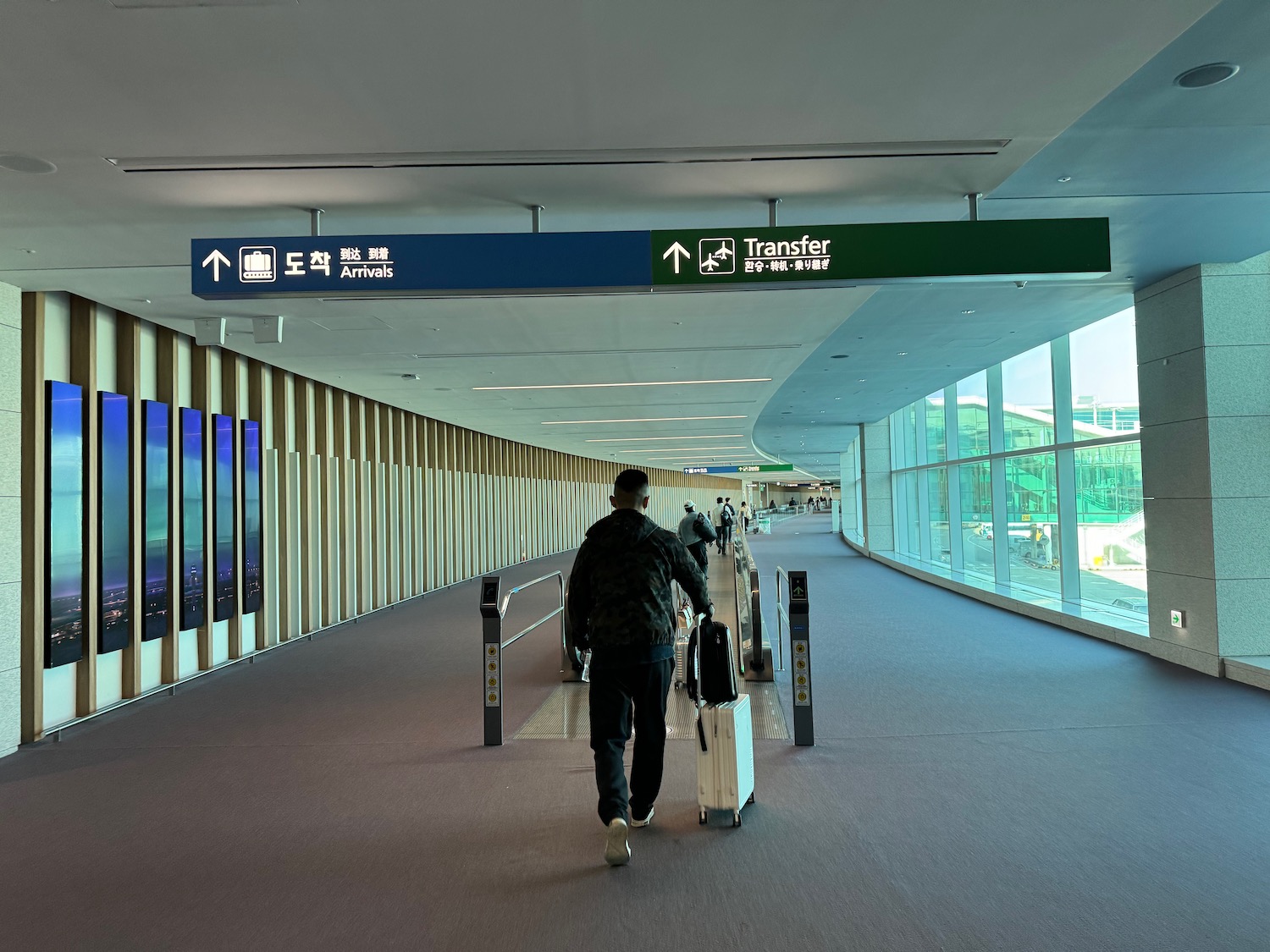 a man walking with luggage in an airport