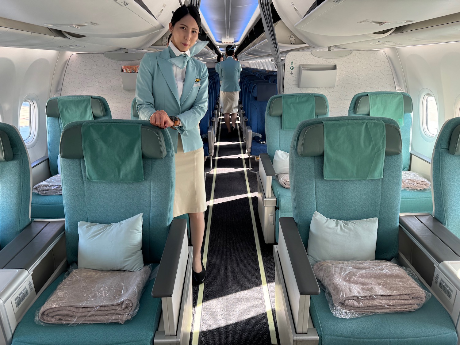 a woman standing in an airplane