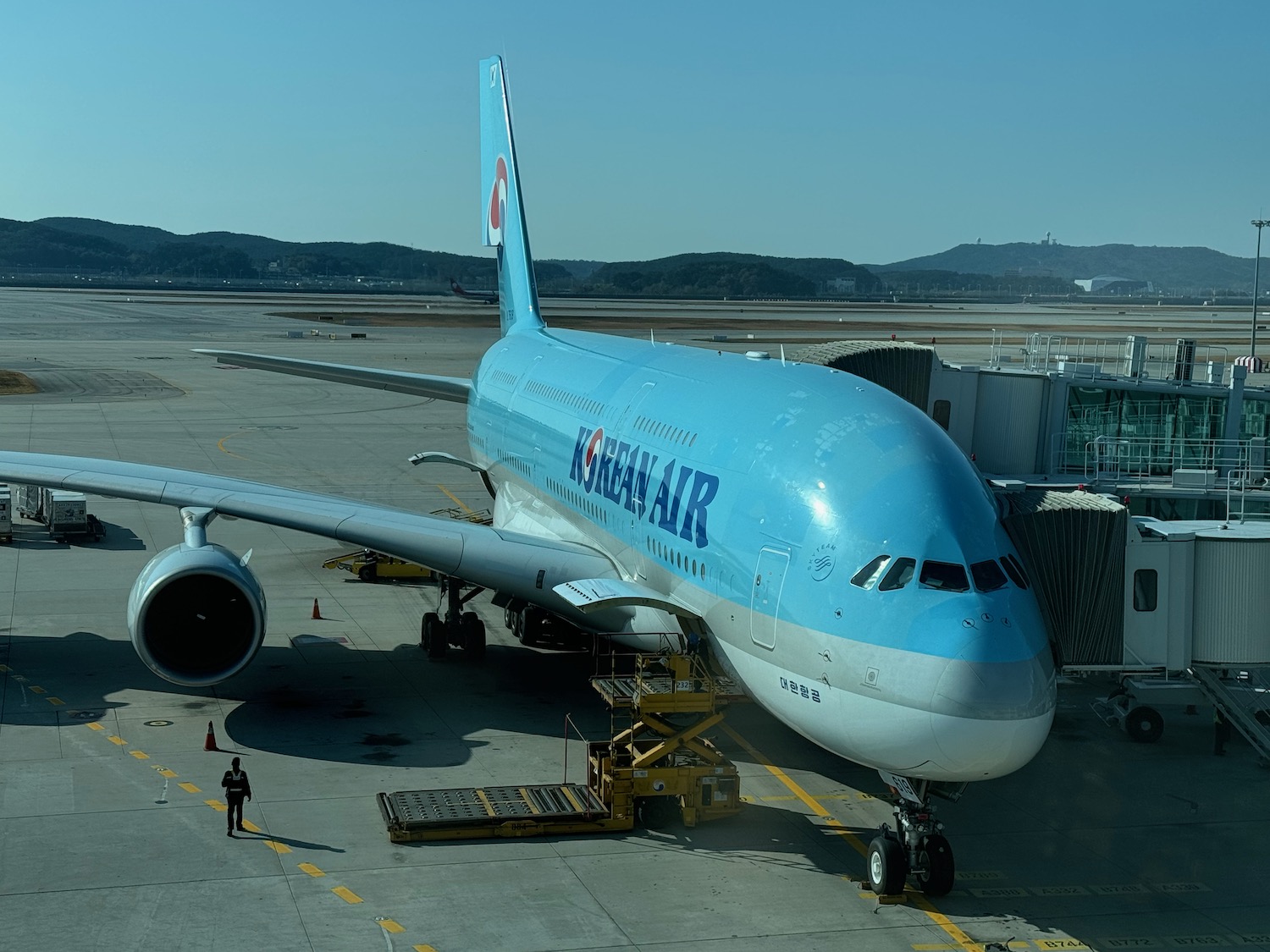 a blue airplane on a tarmac