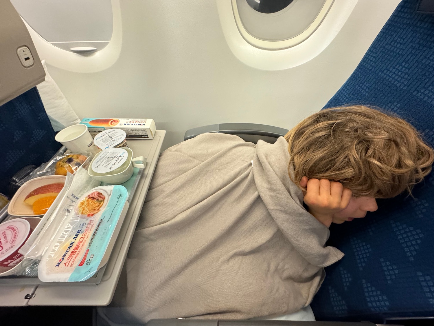 a child sleeping on an airplane