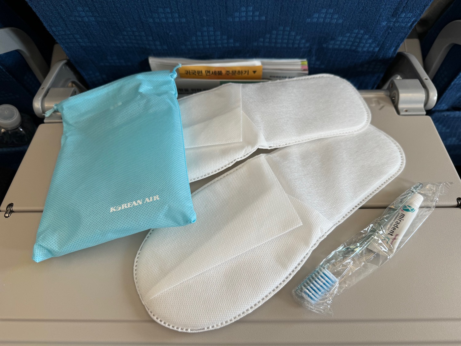 a group of white masks and a blue bag on a table