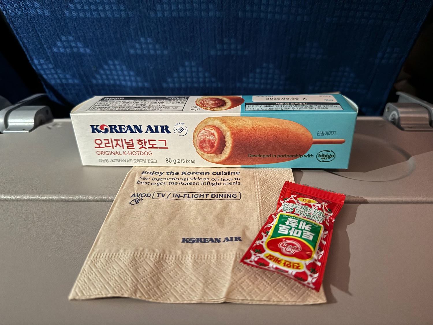 a box of food and a napkin on a table