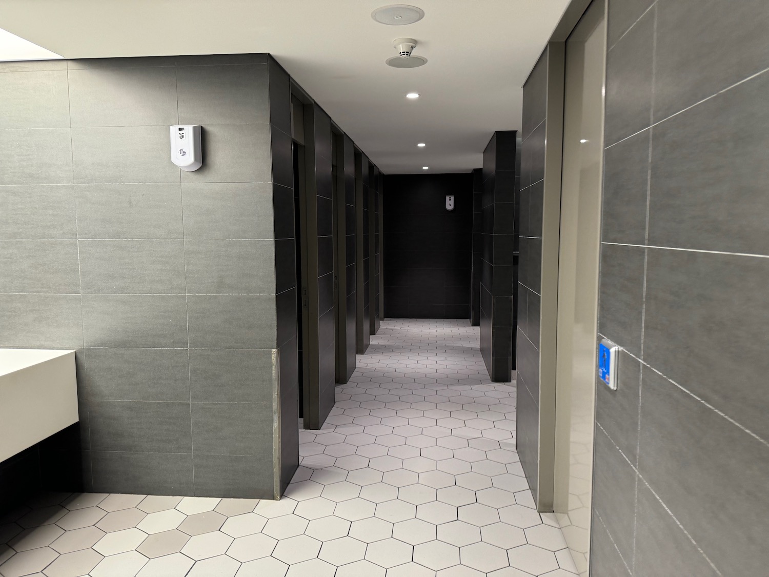 a hallway with grey tiles