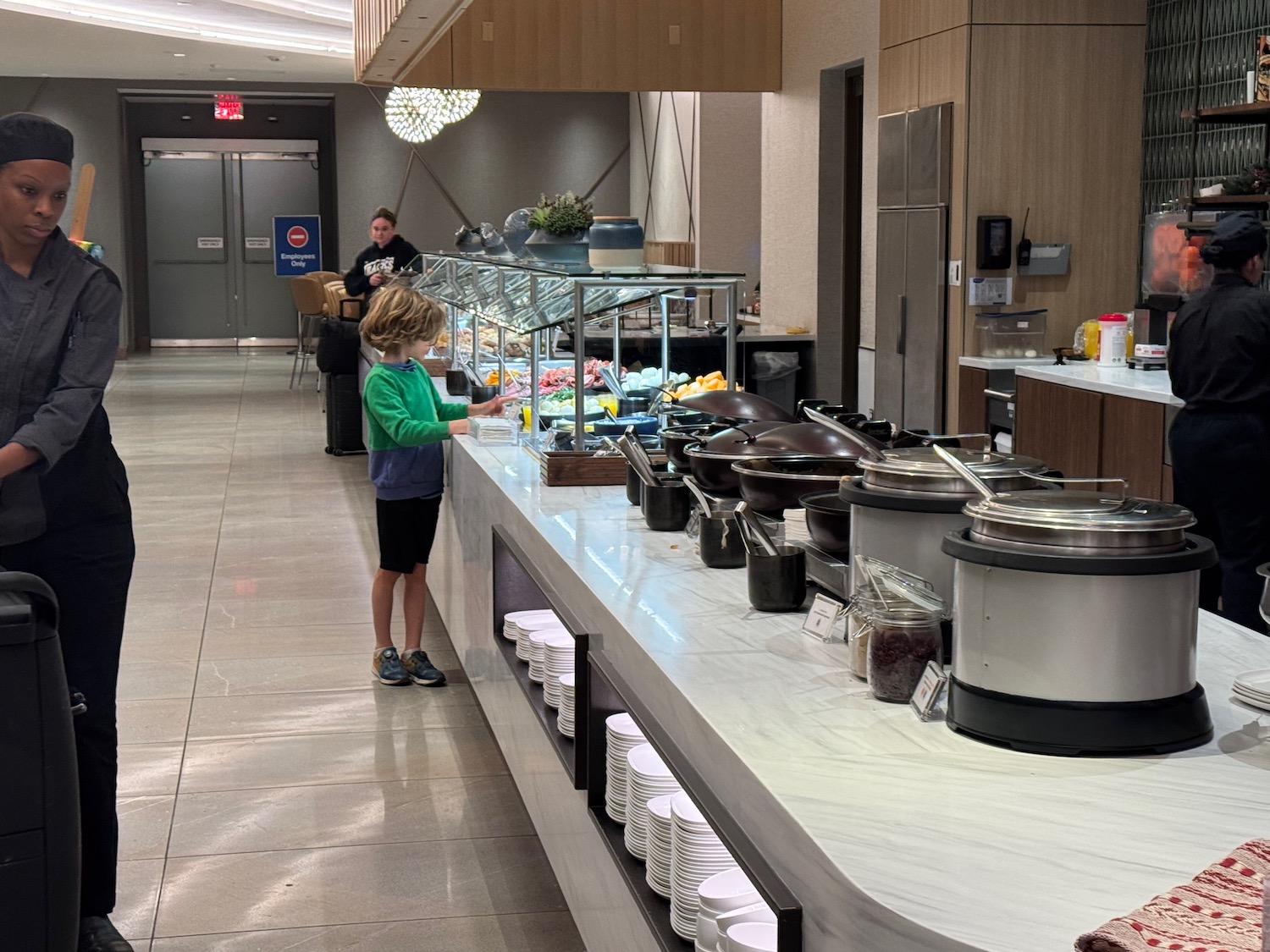 a boy standing at a buffet