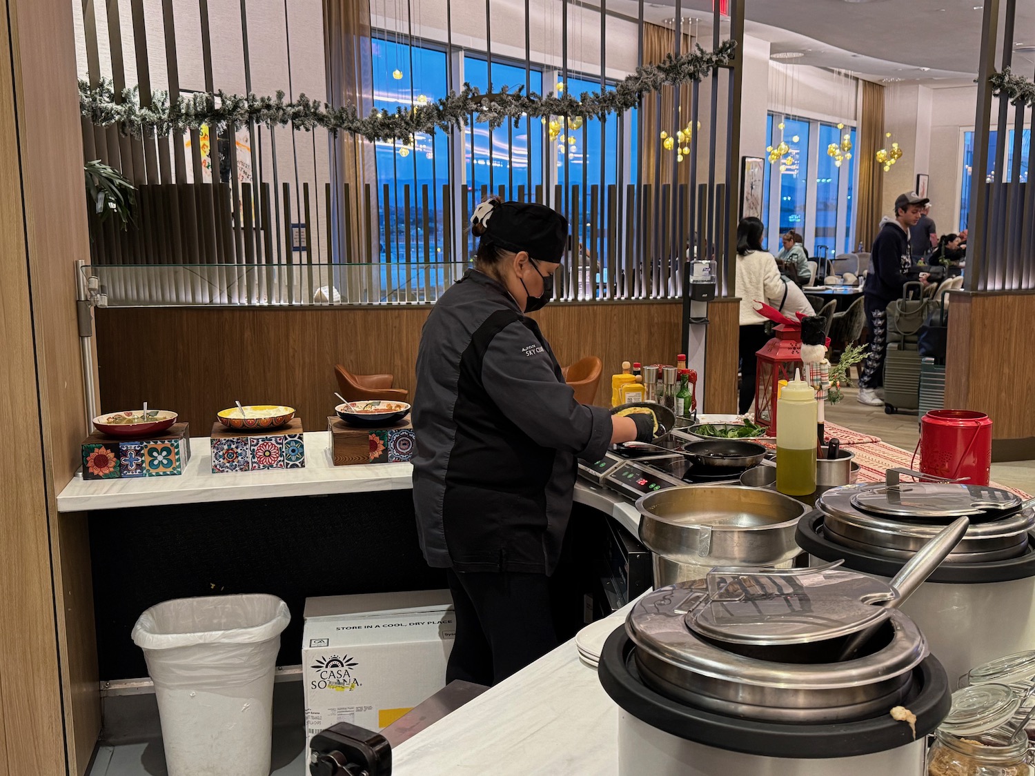 a person in a black mask cooking food