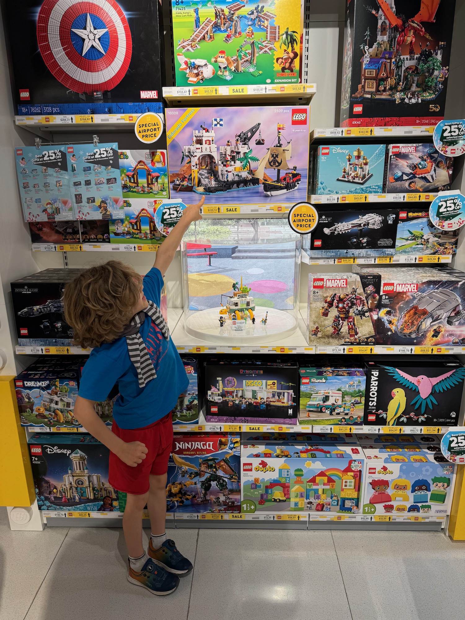 a child pointing at a toy display