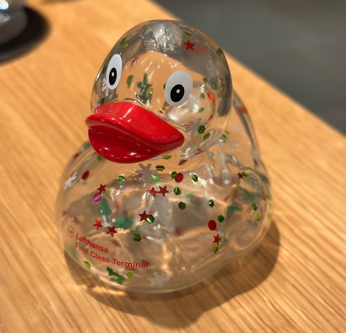 a clear plastic duck with a red beak