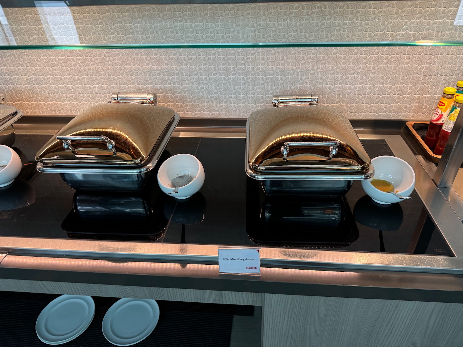 a group of silver containers on a black counter