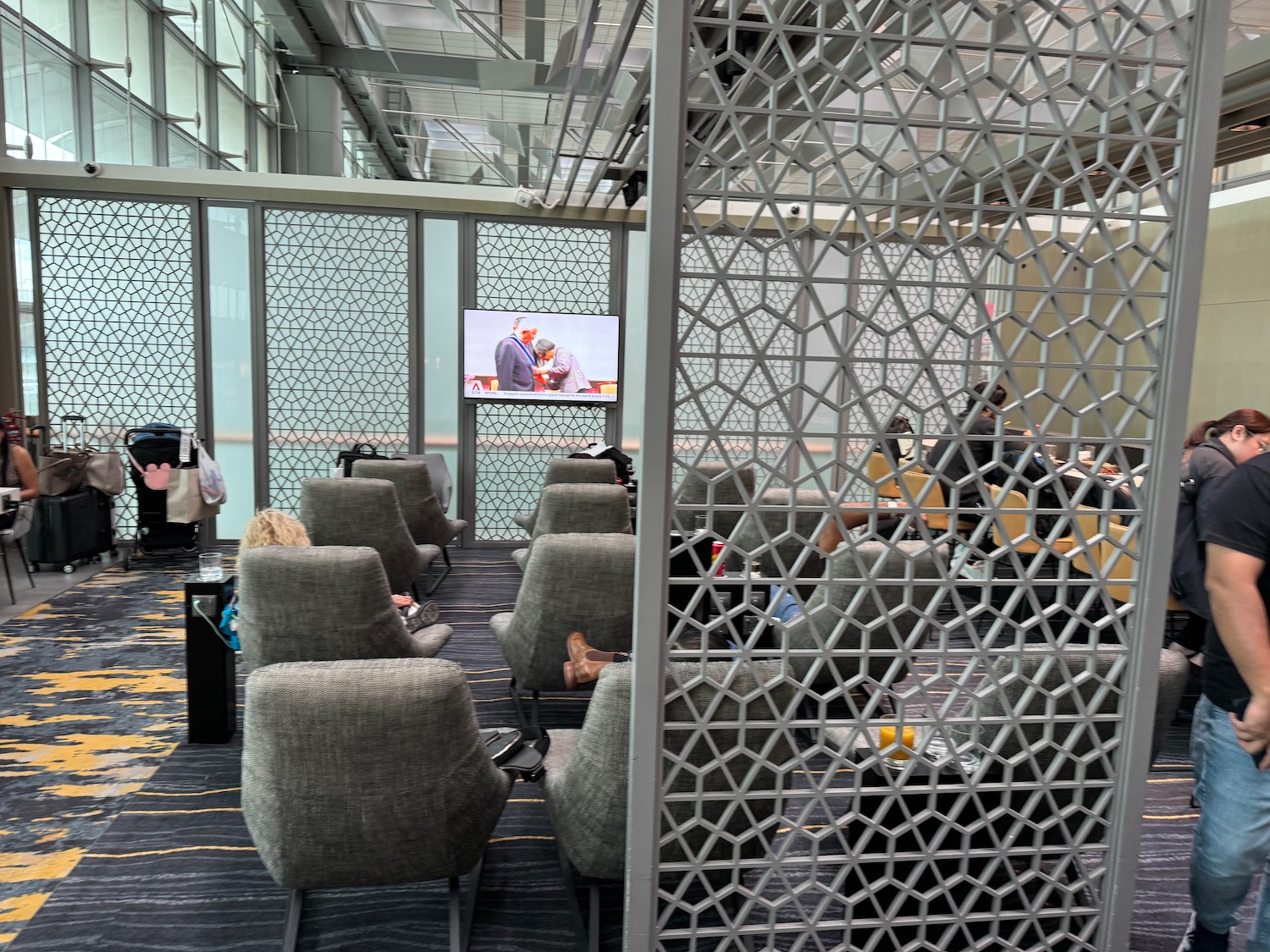 a room with grey chairs and a screen