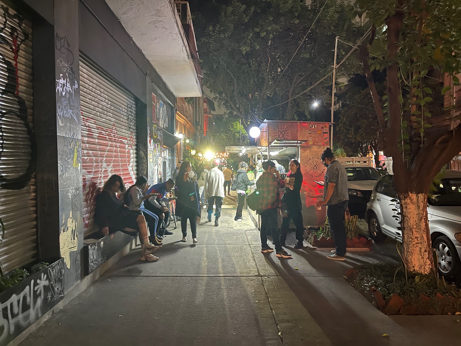 a group of people on a sidewalk